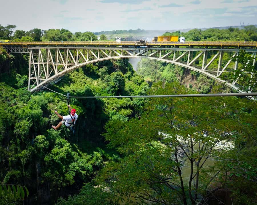 From Victoria Falls: Zip Line from the Victoria Falls Bridge - The Ride Begins on the Zambian Edge: Slide Setup and Big Falls Views