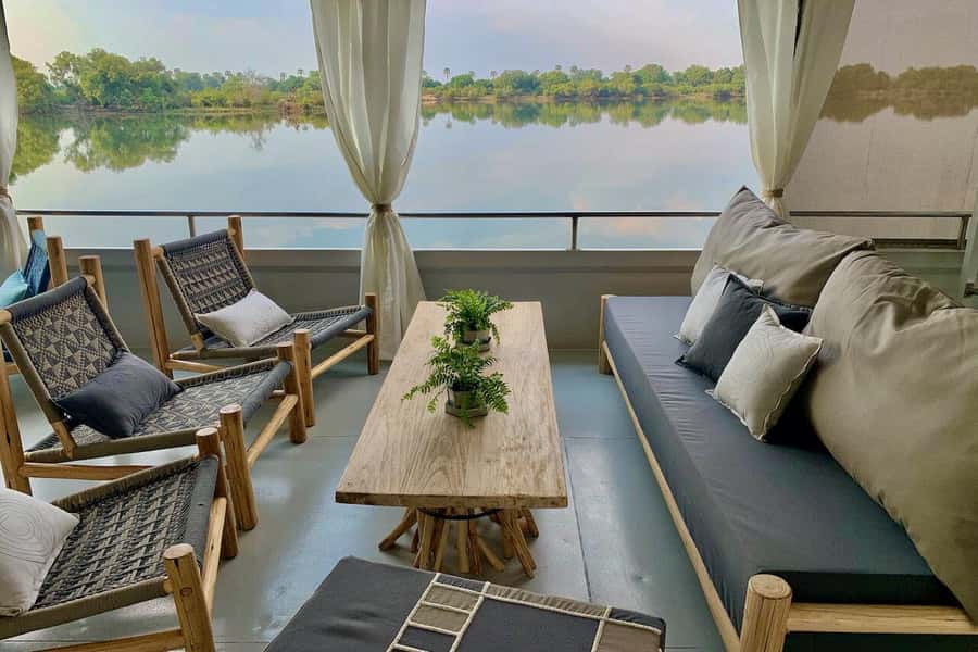 Luxury Cruise : Sunset Boat Cruise on The Zambezi Explorer - Zambezi National Park cruising and the distant smoke from Victoria Falls